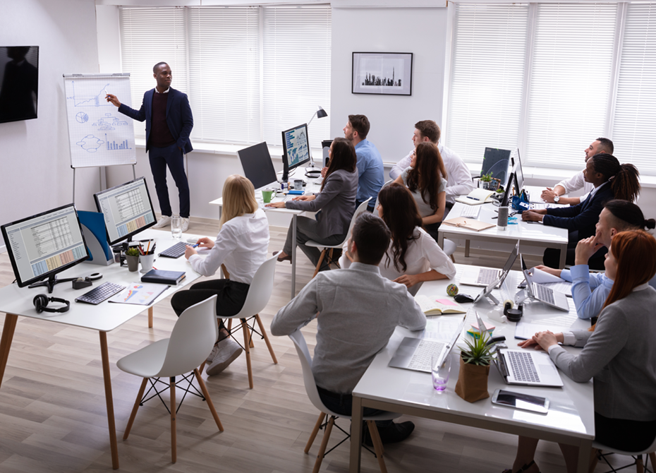 A professional training session in progress, with a diverse group of employees actively engaging and learning. This reflects the company's commitment to social responsibility through ongoing training and development initiatives that empower its workforce.