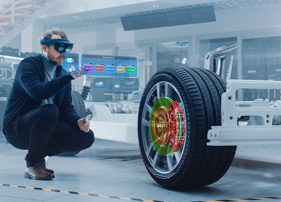 An engineer works on a project in a high-tech environment, using augmented reality to analyze a car wheel and brake system as part of advanced automotive project business.