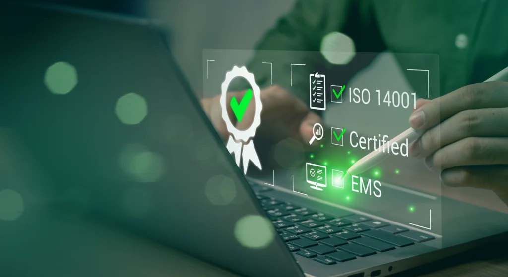 A person interacts with a digital display showing certificates such as ISO 14001, Certified, and EMS, emphasizing the company's compliance and standards like ISO and TISAX.