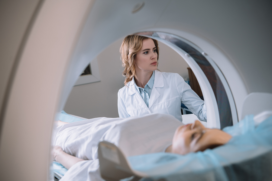 A doctor assists a patient during an MRI scan, using cutting-edge equipment that reflects the role of medical technology in modern diagnostics.