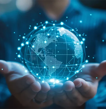 Hands hold a digital globe with glowing connections, illustrating prototyping processes within a global network of innovation and technology.