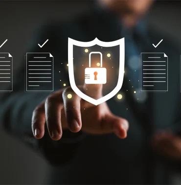 A person interacts with a digital shield featuring a padlock, symbolizing data security and governance. Surrounding the shield are documents with checkmarks, representing compliance, protection, and regulatory governance.